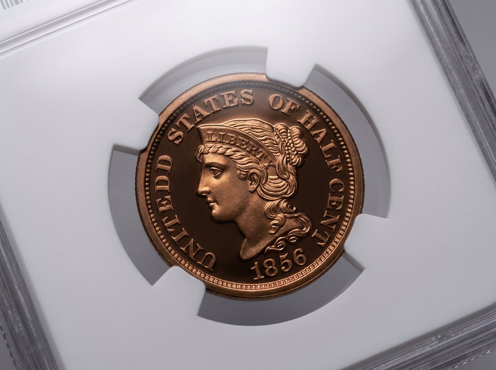Graded proof half cent in original mint packaging showing mirrored surfaces